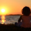 Relaxing young child in sunset